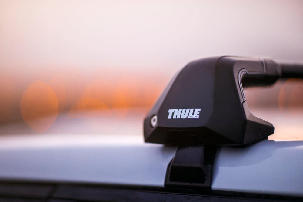Thule car roof rack mounted on a vehicle with a blurred background