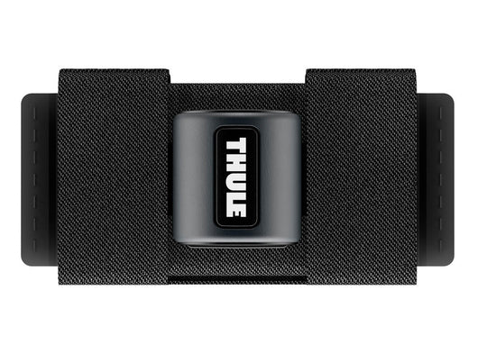 A black Thule SkiClick ski carrier with the Thule logo visible on the strap, designed for transporting cross-country skis.