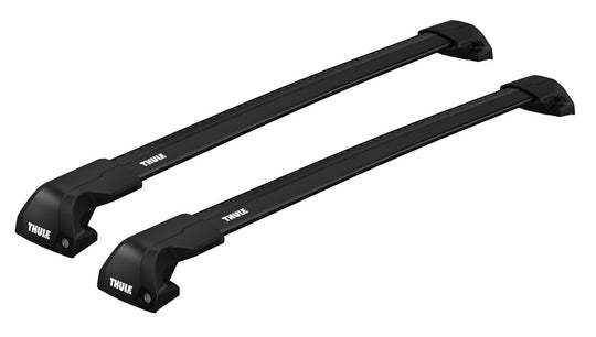 Two black Thule roof bike racks on a white background